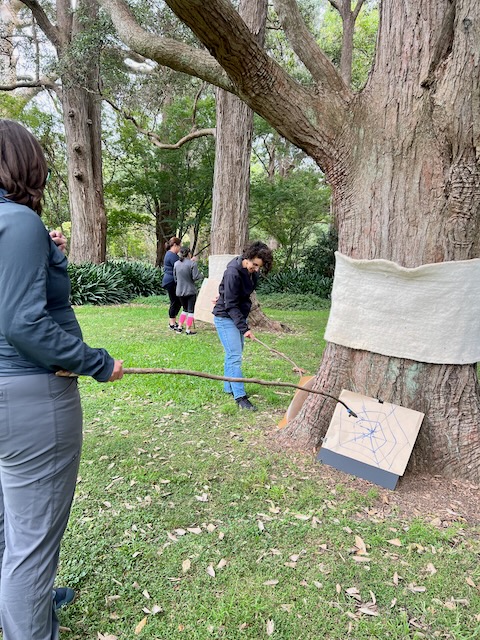 drawing with sticks under the trees